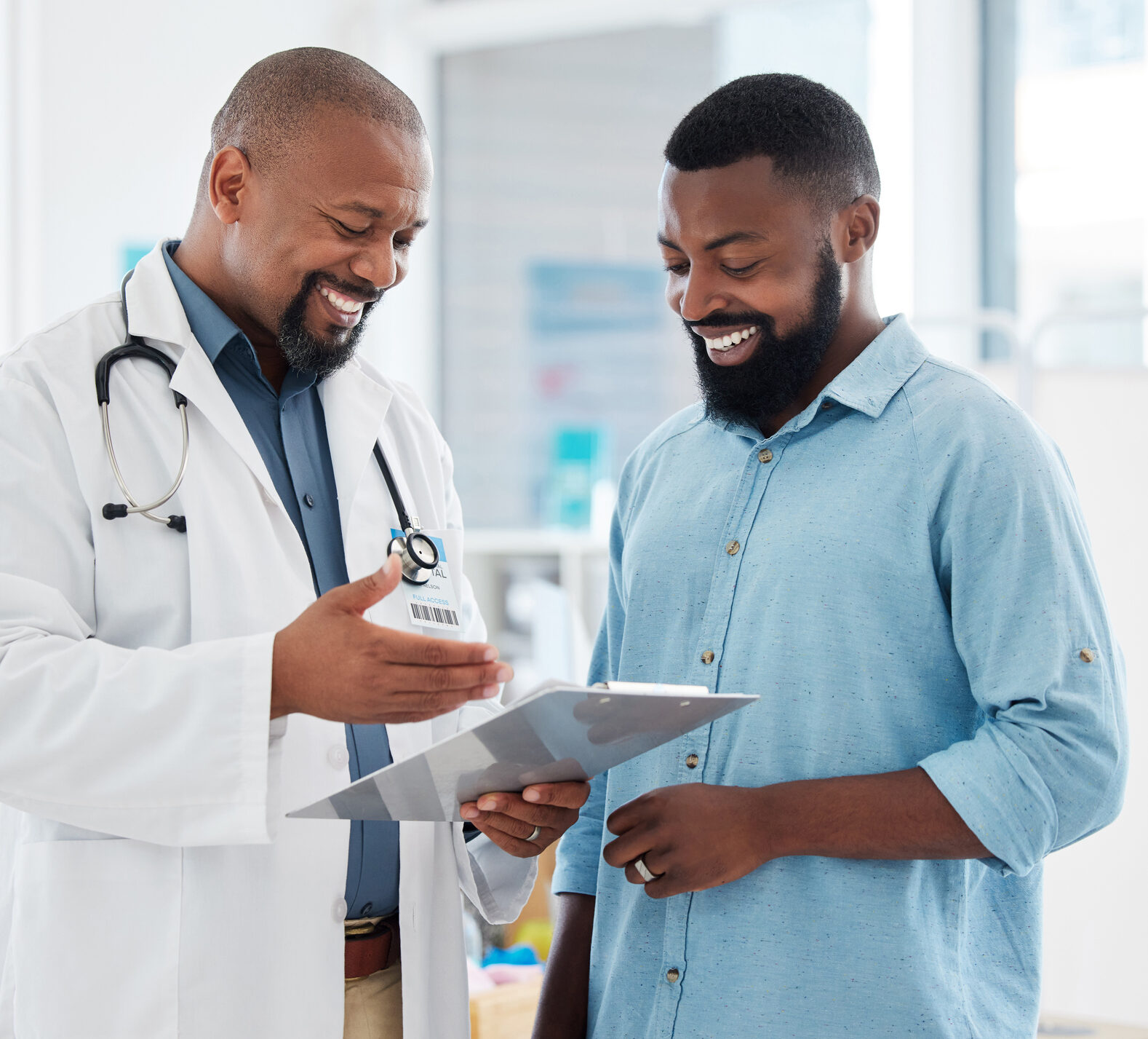 Doctor smiling looking at a chart with his patient with diabetes
