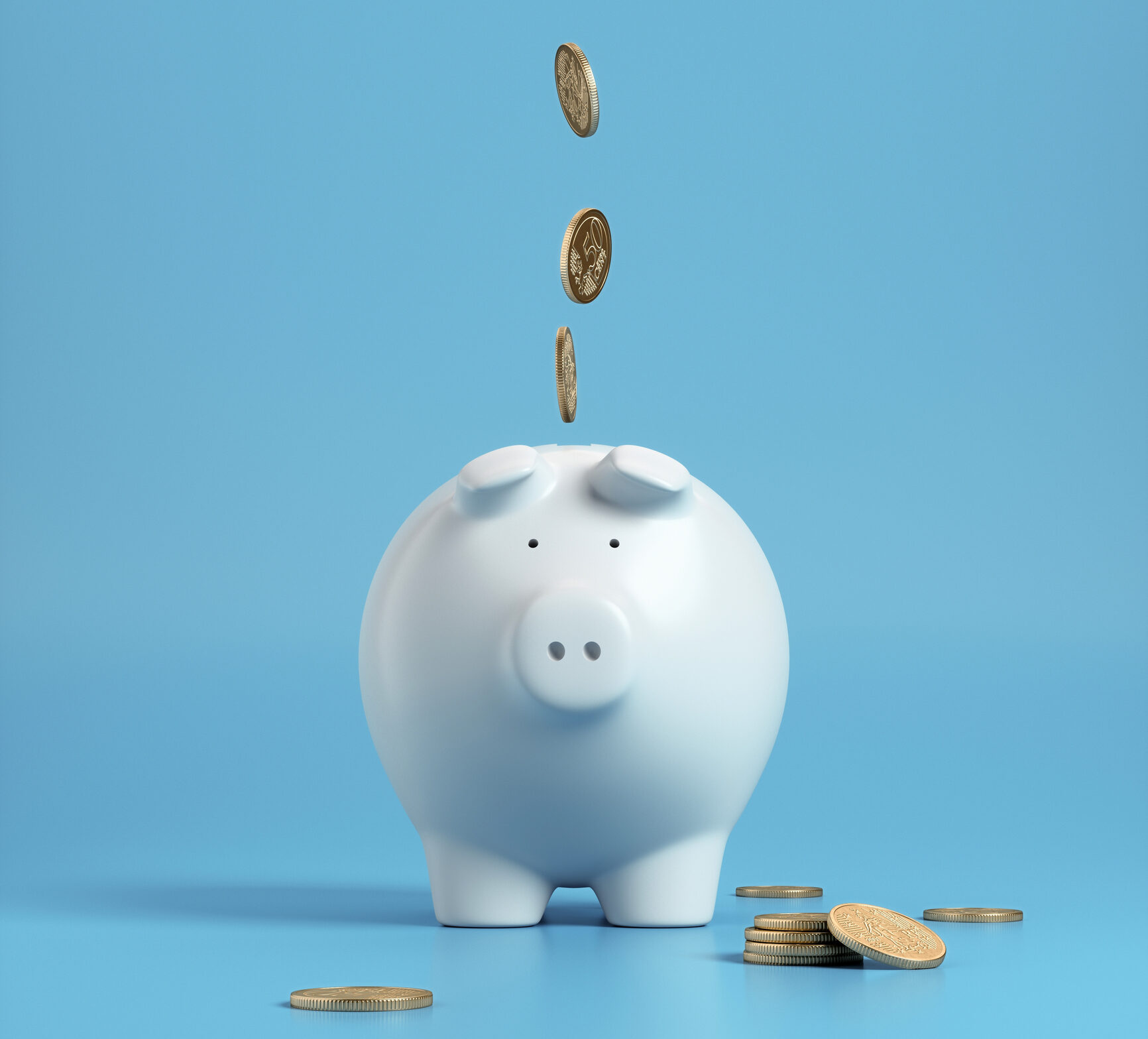 Falling coins in to a white piggy bank with a blue background