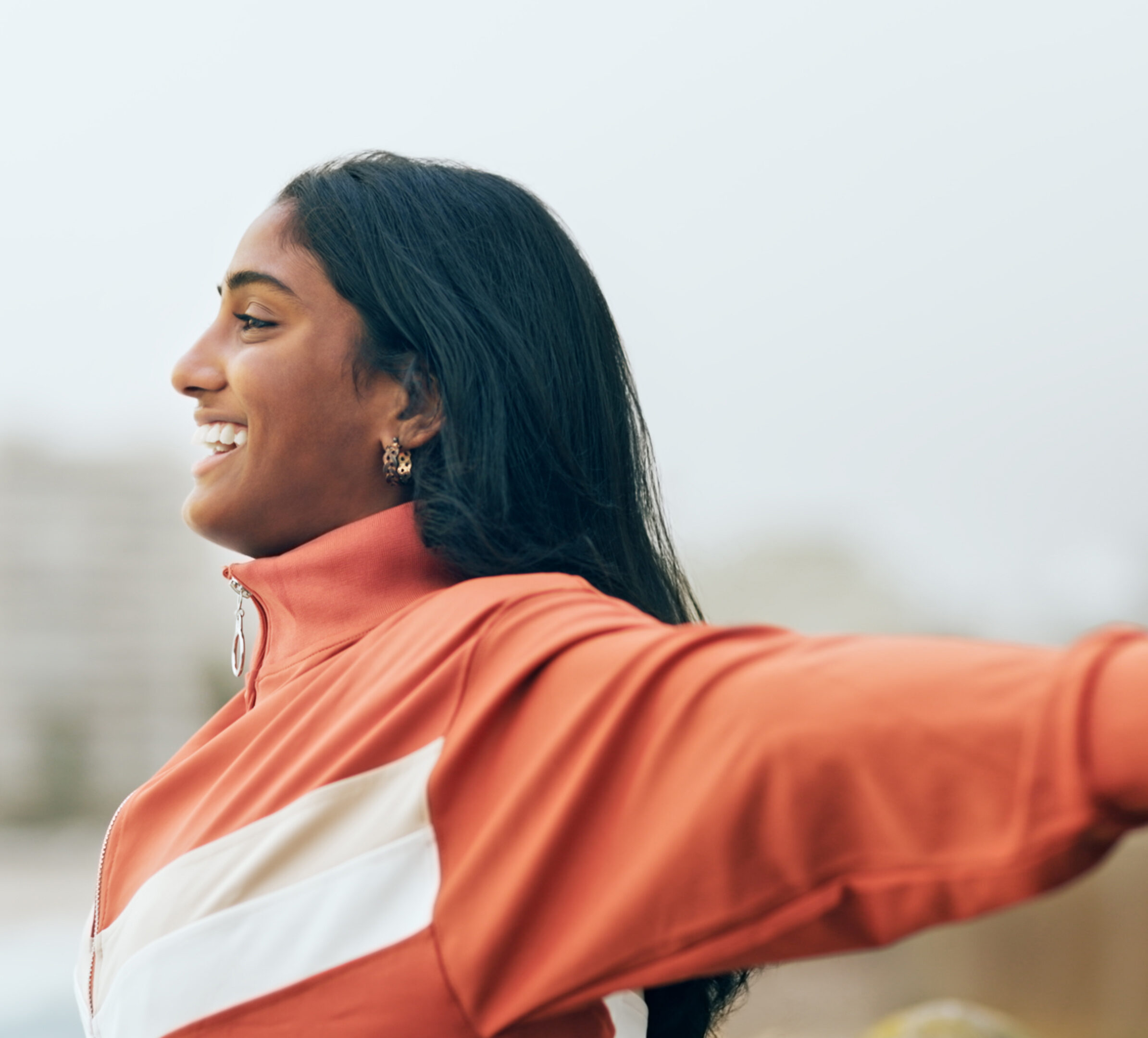 Woman smiling with her arms out feeling free with time in range!