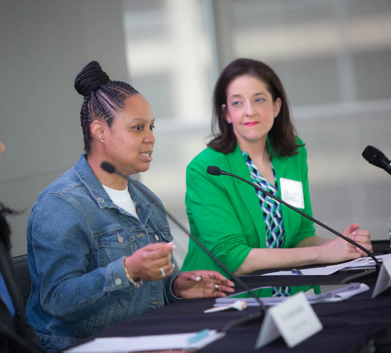 two women with diabetes speaking about time in range at a podium