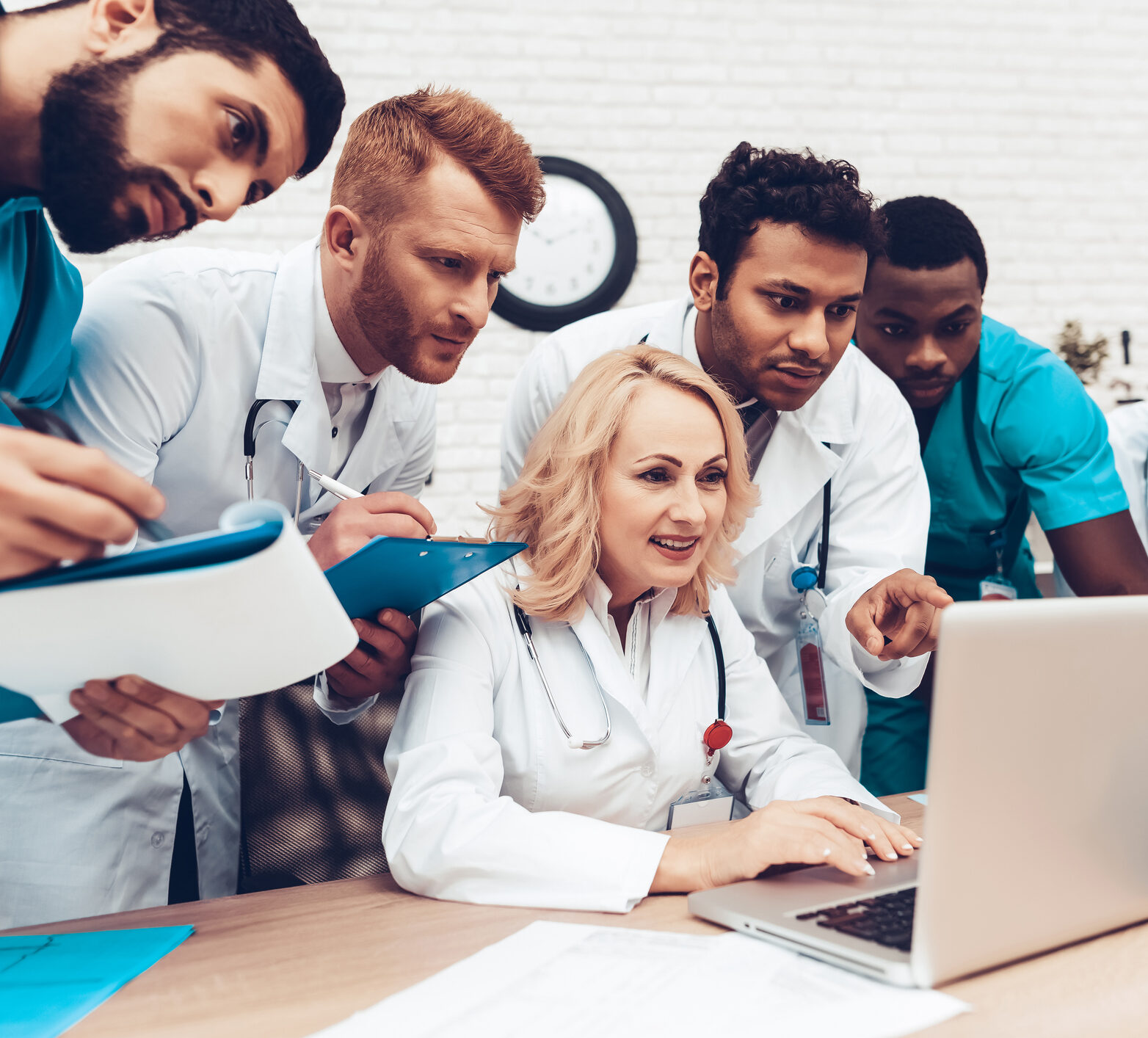 Team of doctors looking at a laptop learning about time in range