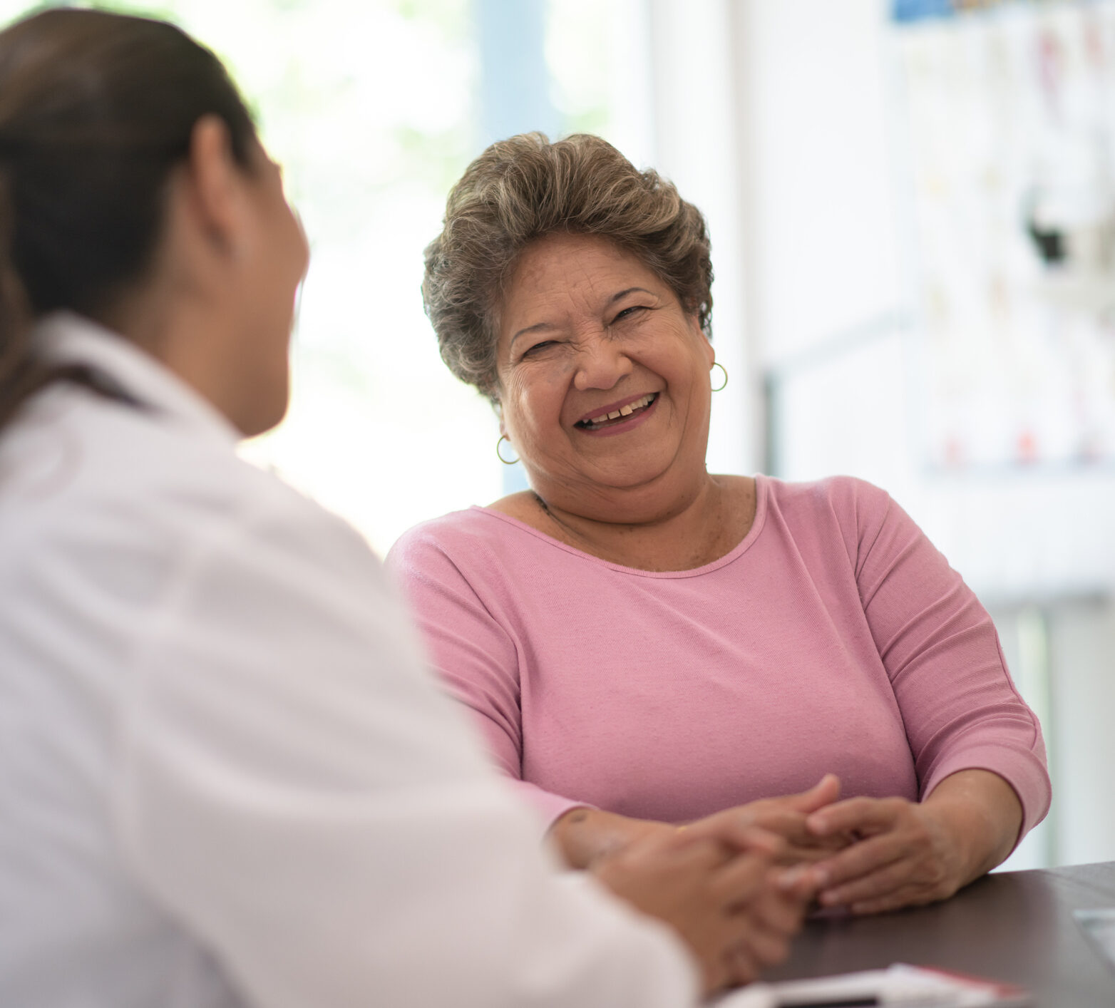 Older woman speaking and consulting with the doctor about her concerns