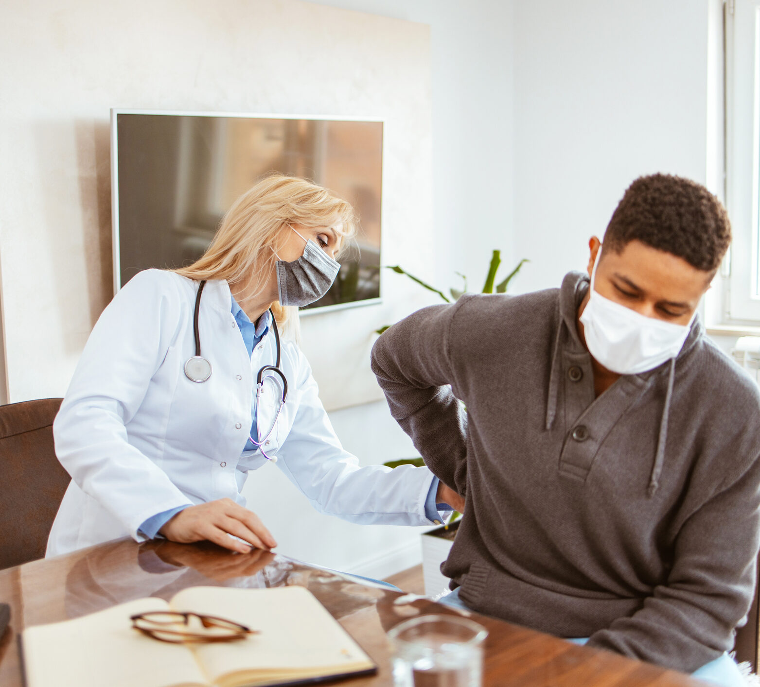 Young man with diabetes getting his kidney checked by a female doctor