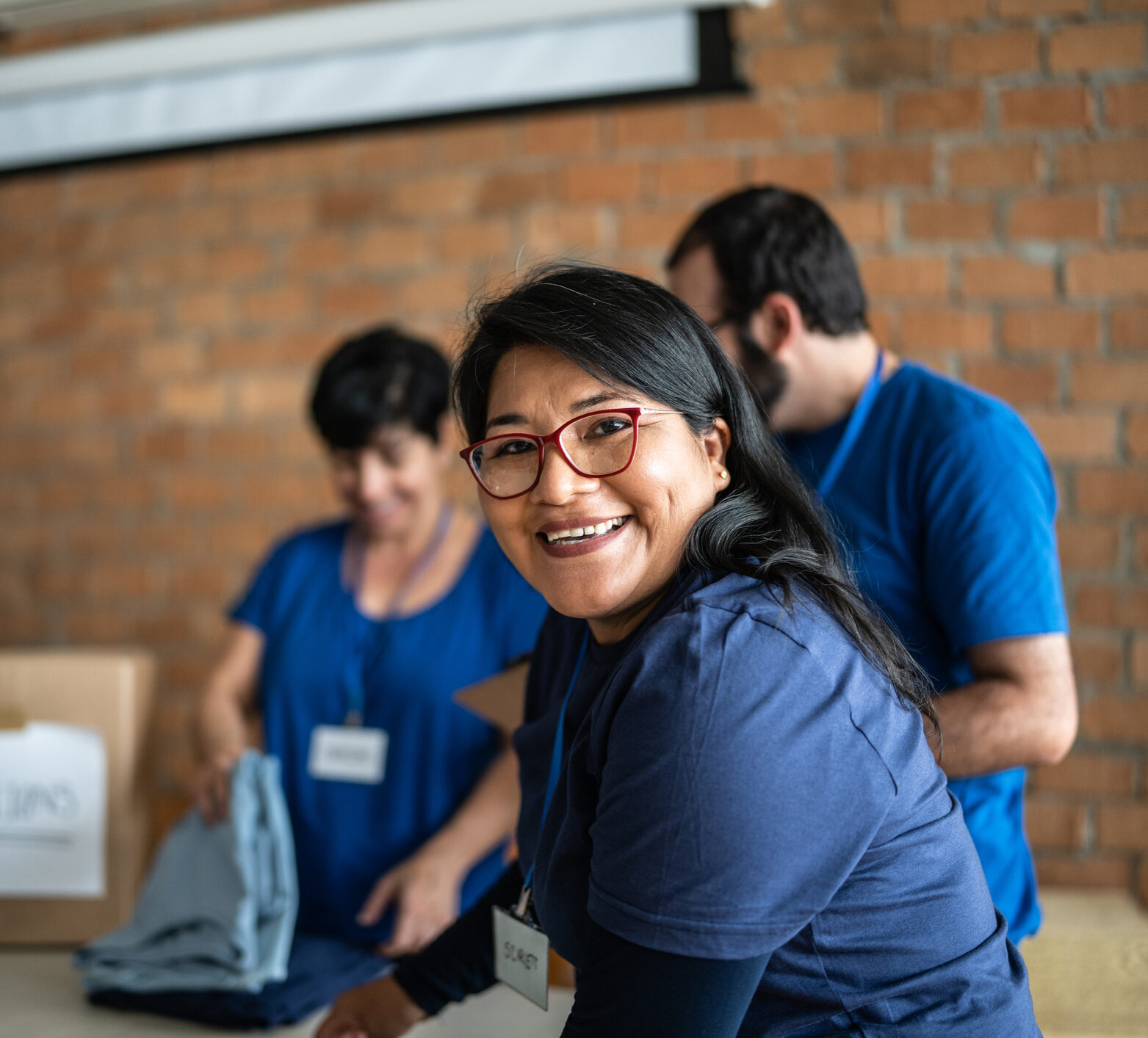 Portrait of a volunteer smiling in a blue shirt