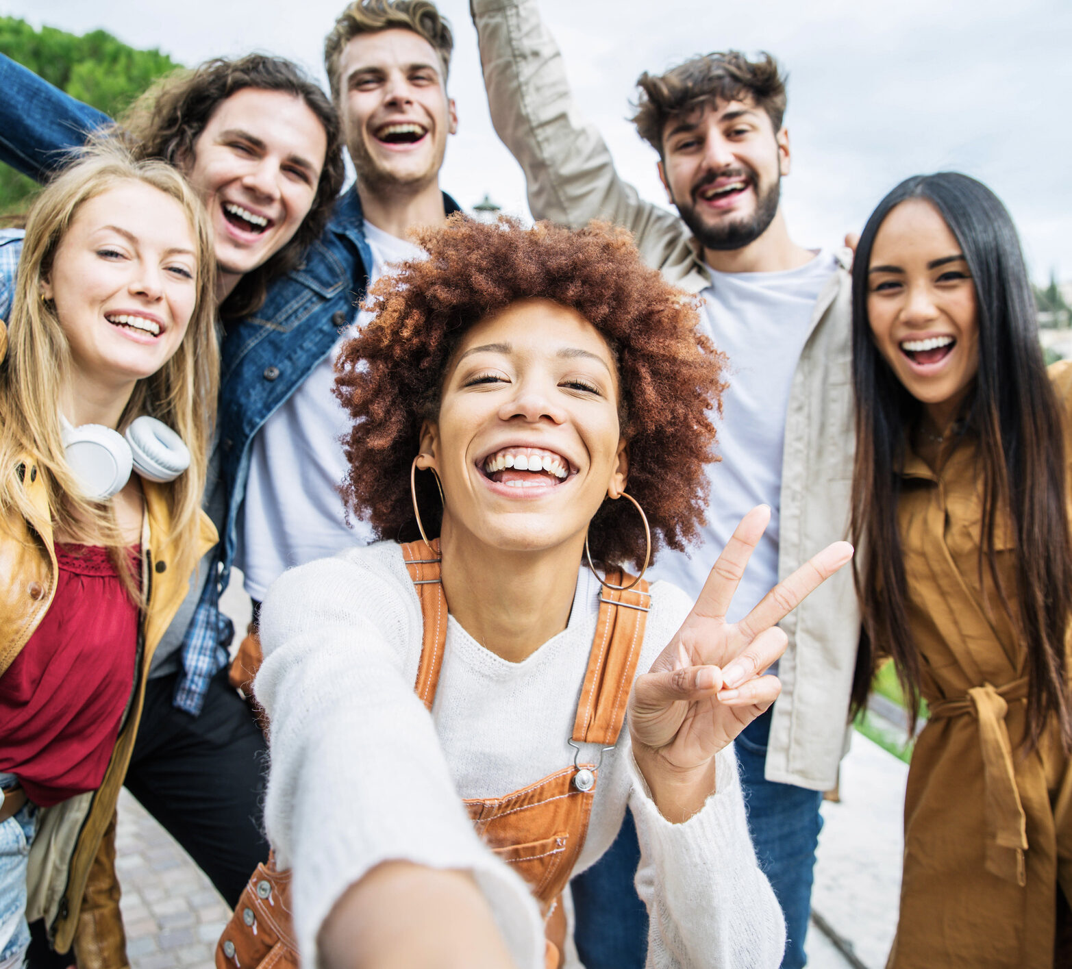 Group of happy friends taking selfie pic outside