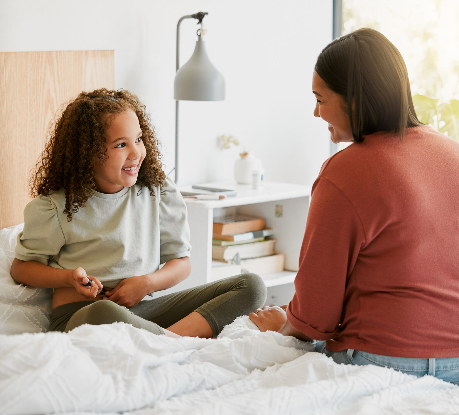 Caring mother teaching child to take insulin injection by herself looking happy, proud and brave at home.