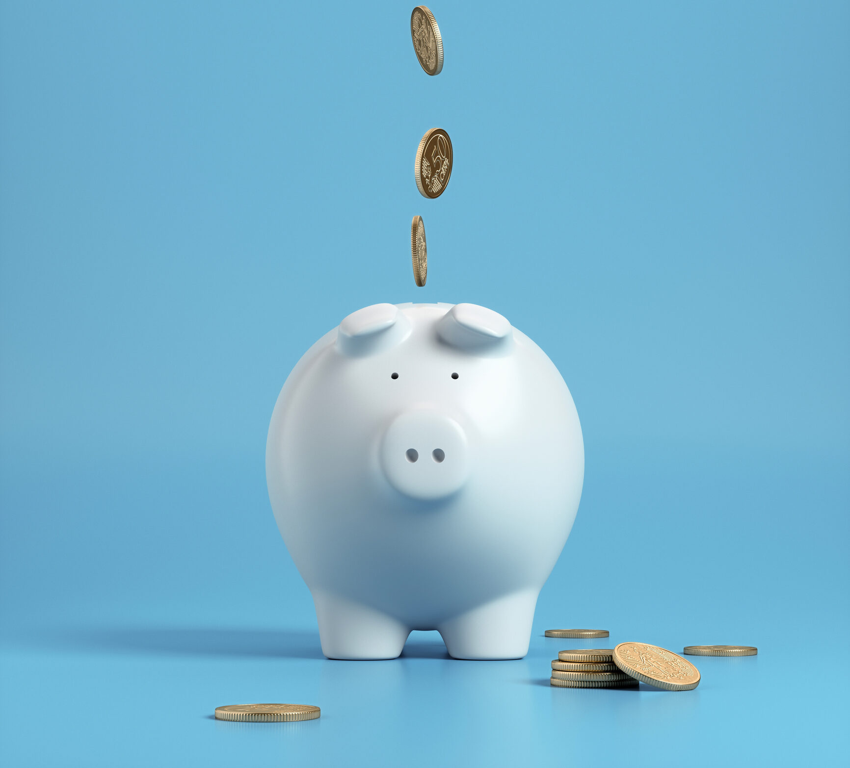 Falling coins in to a white piggy bank with a blue background