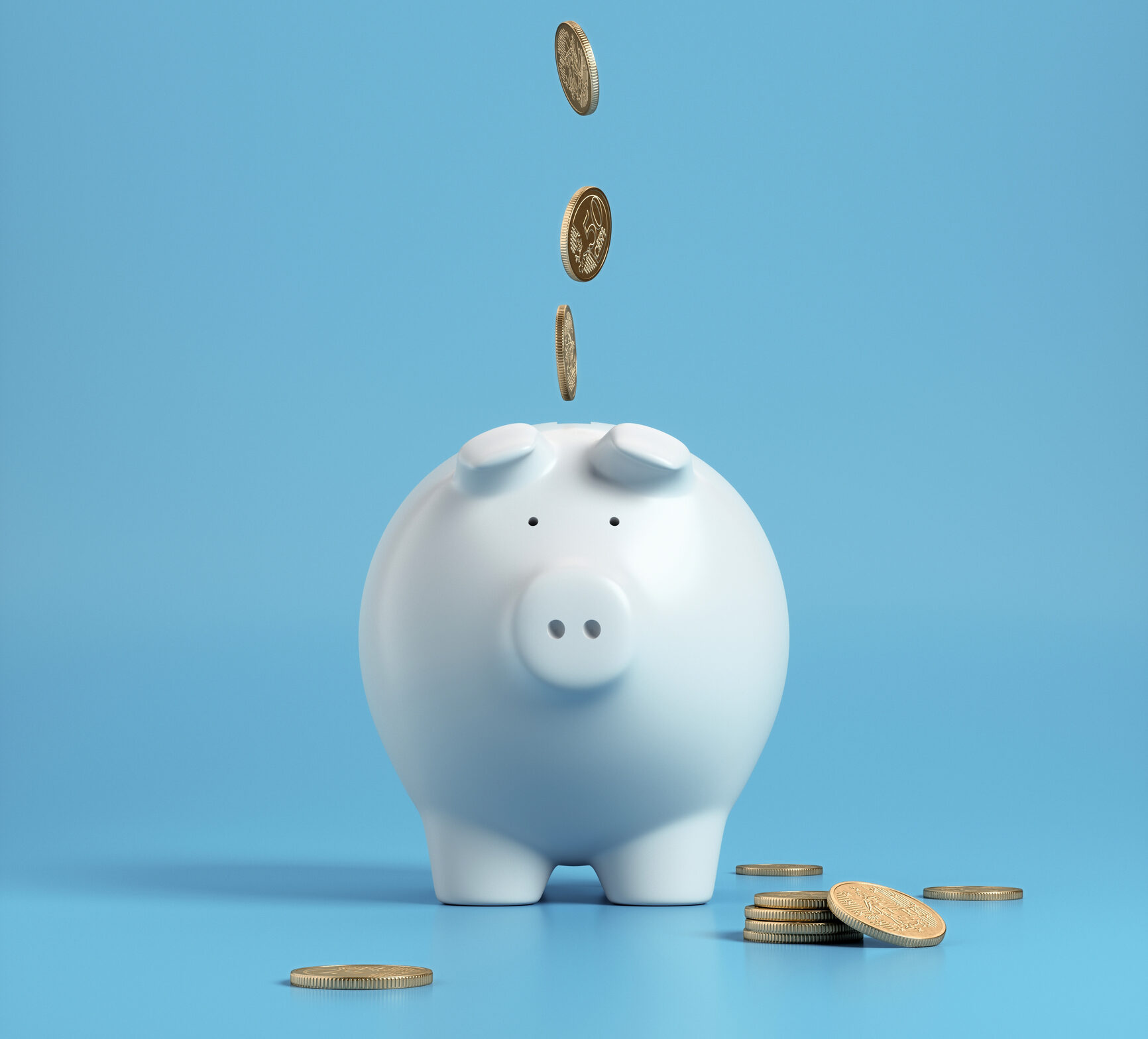Falling coins in to a white piggy bank with a blue background