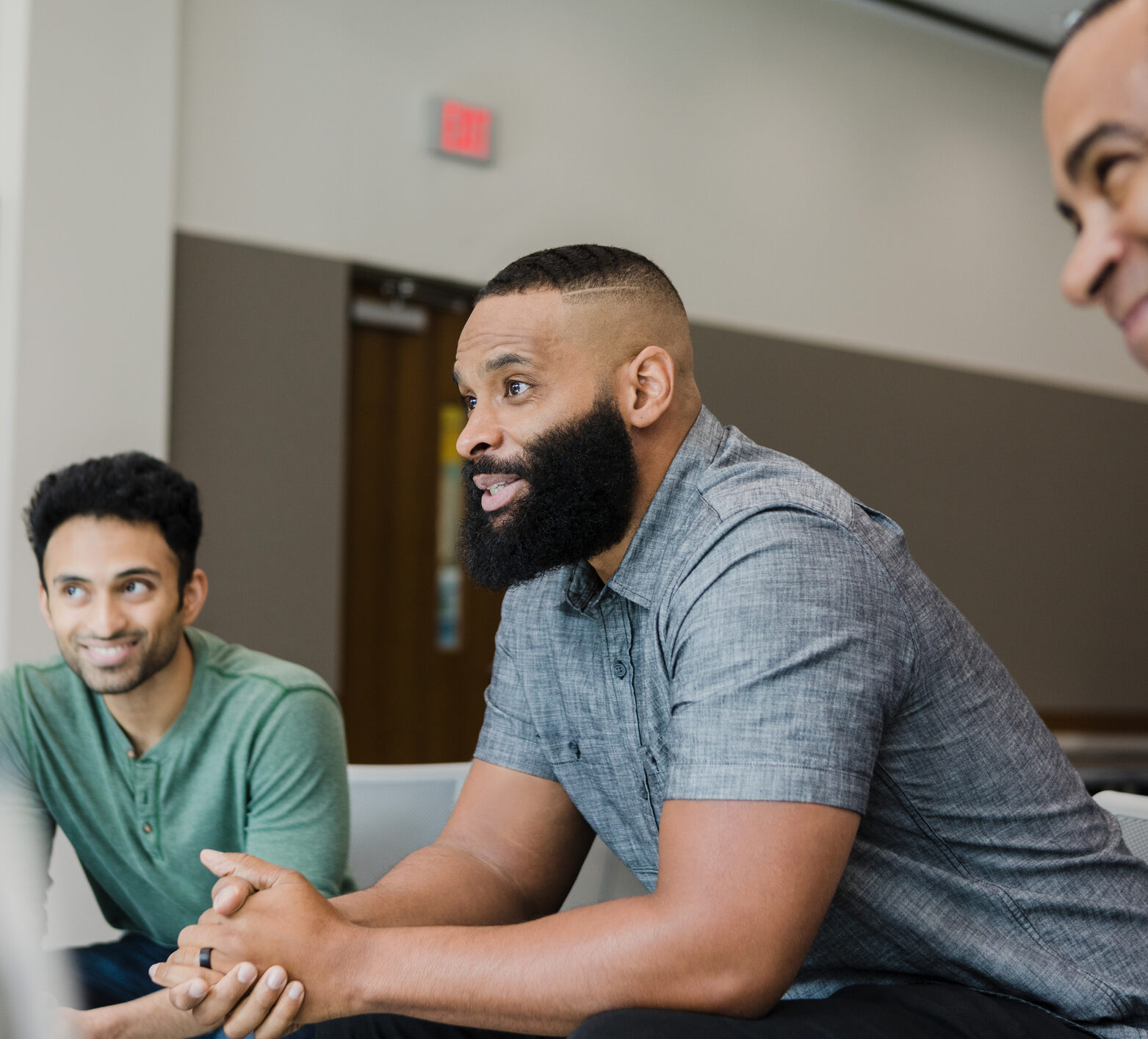 Three men sitting down talking to each other about their time in range experience