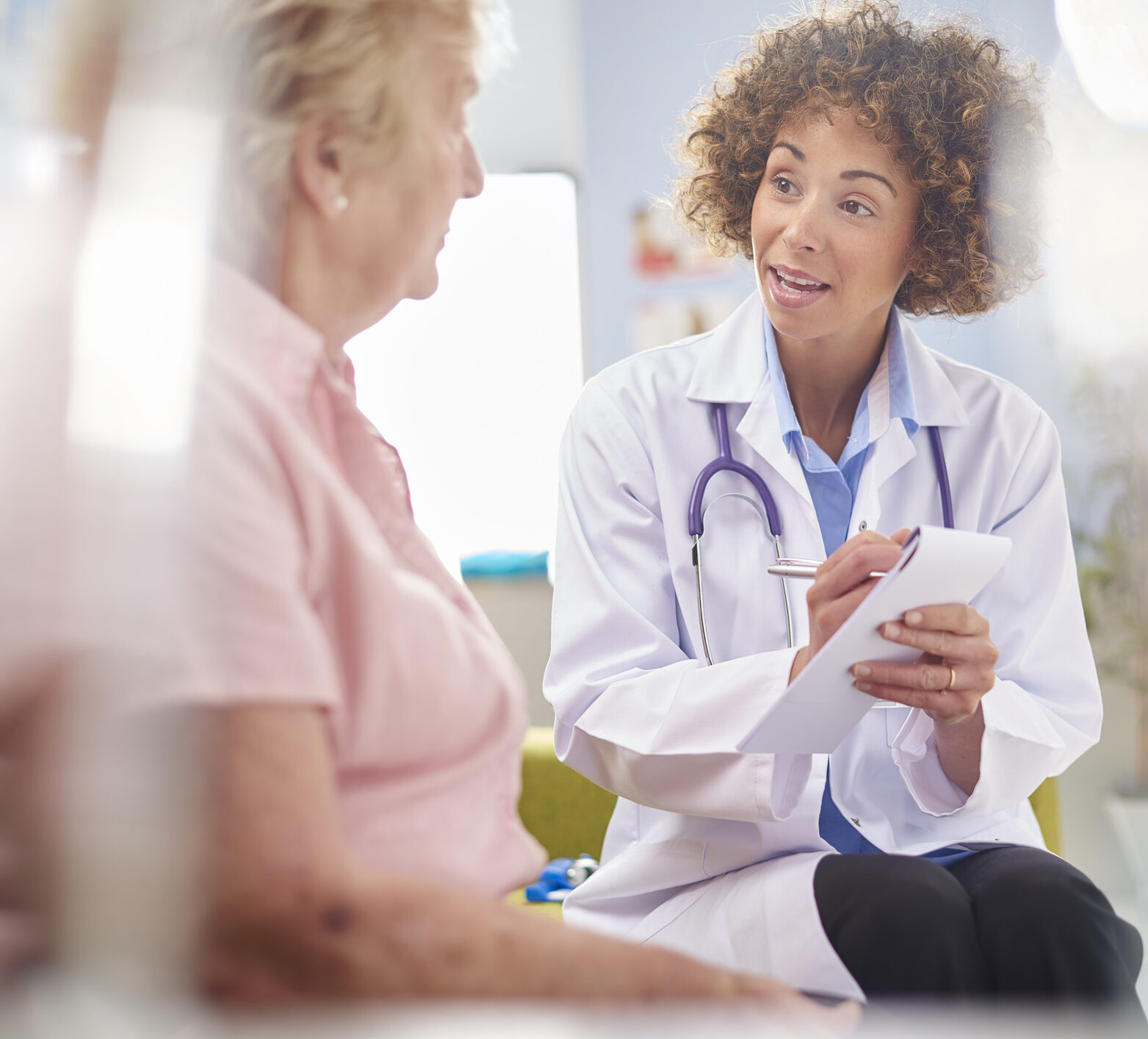 a female doctor sits and listens to a woman with diabetes talk about her fluctuations in her glucose levels