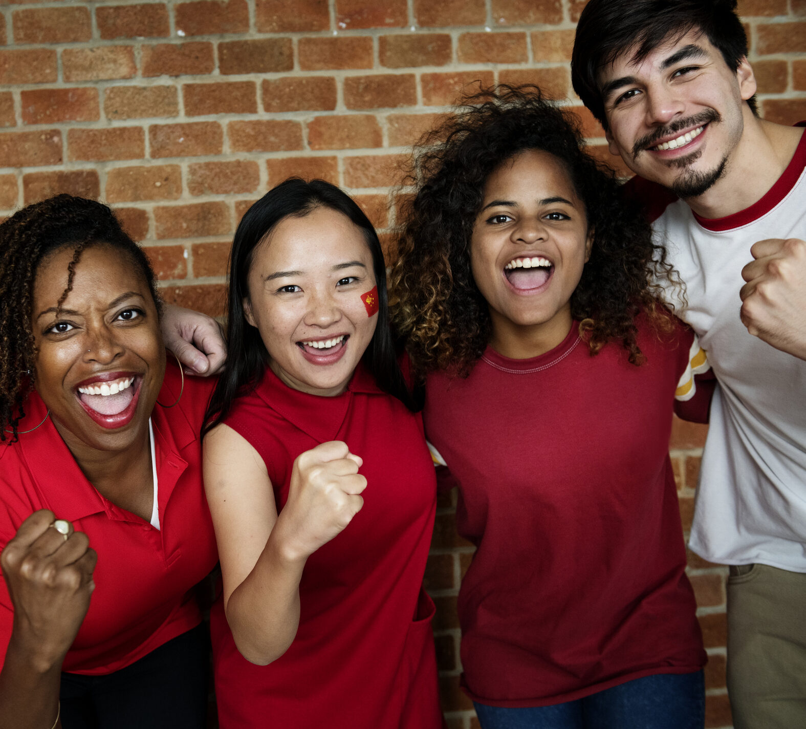 Friends cheering wearing red